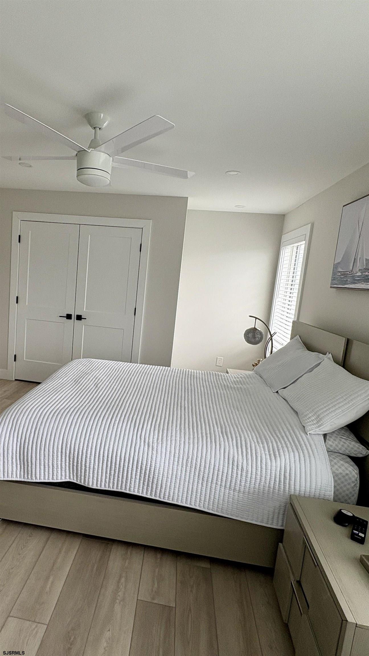 15 North Jefferson Avenue, Unit B Margate City, NJ 08402 - Photo 9 of 13 a bedroom with a bed and a night stand