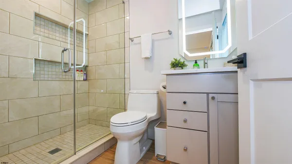 a bathroom with a toilet and a shower