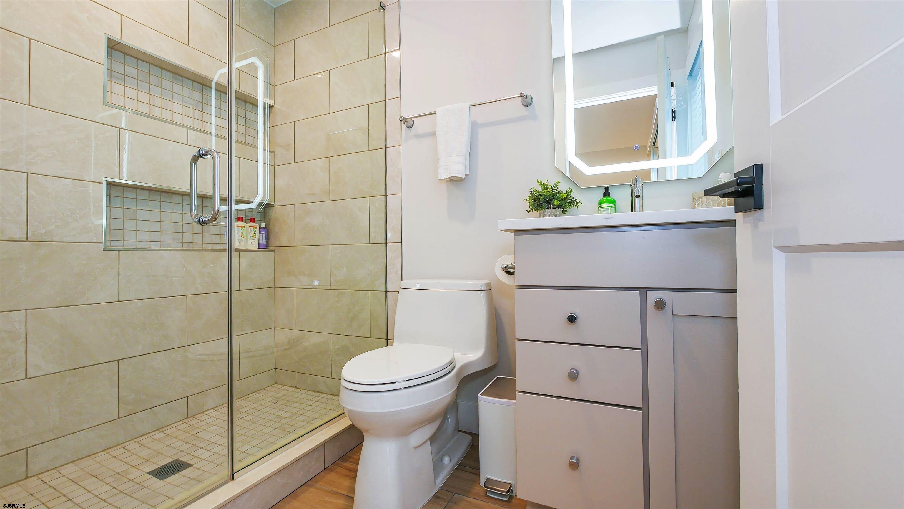 15 North Jefferson Avenue, Unit B Margate City, NJ 08402 - Photo 10 of 13 a bathroom with a toilet and a shower