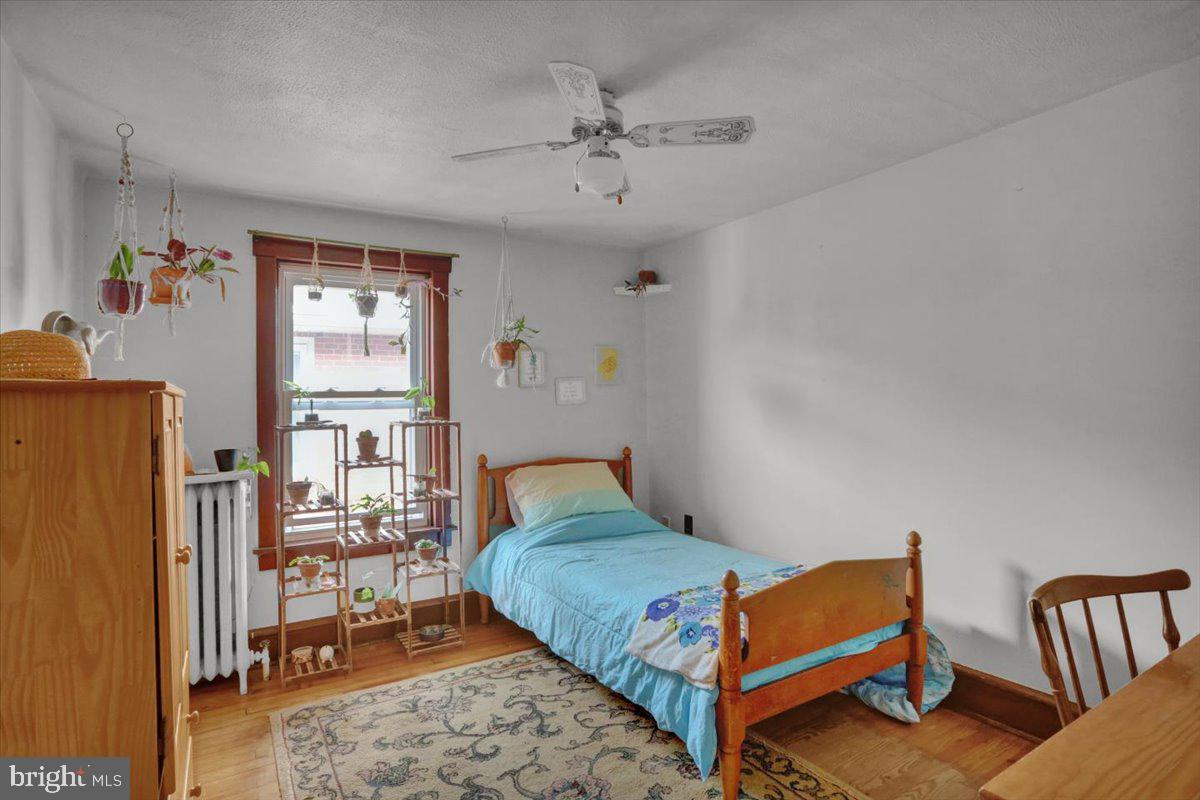 136 West Elm Street Reading, PA 19607 - Photo 15 of 23 a bedroom with furniture and a book shelf