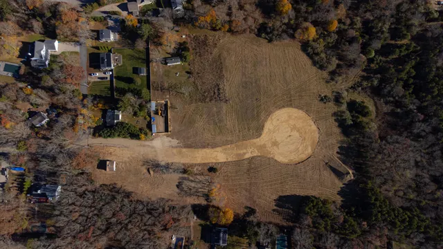 an aerial view of a house with a yard