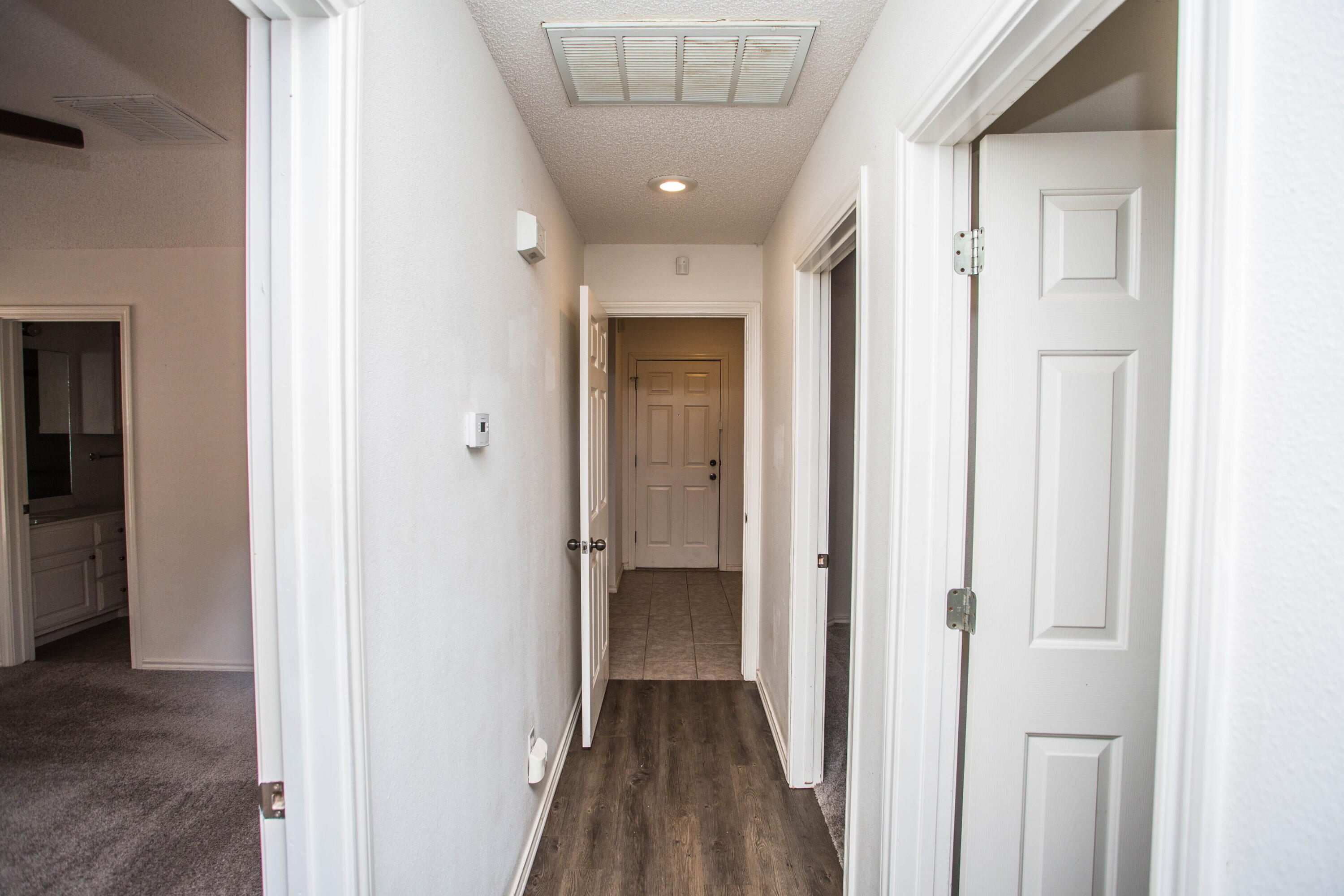 3114 111th Street Lubbock, TX 79423 - Photo 13 of 26 a view of a hallway with wooden floor