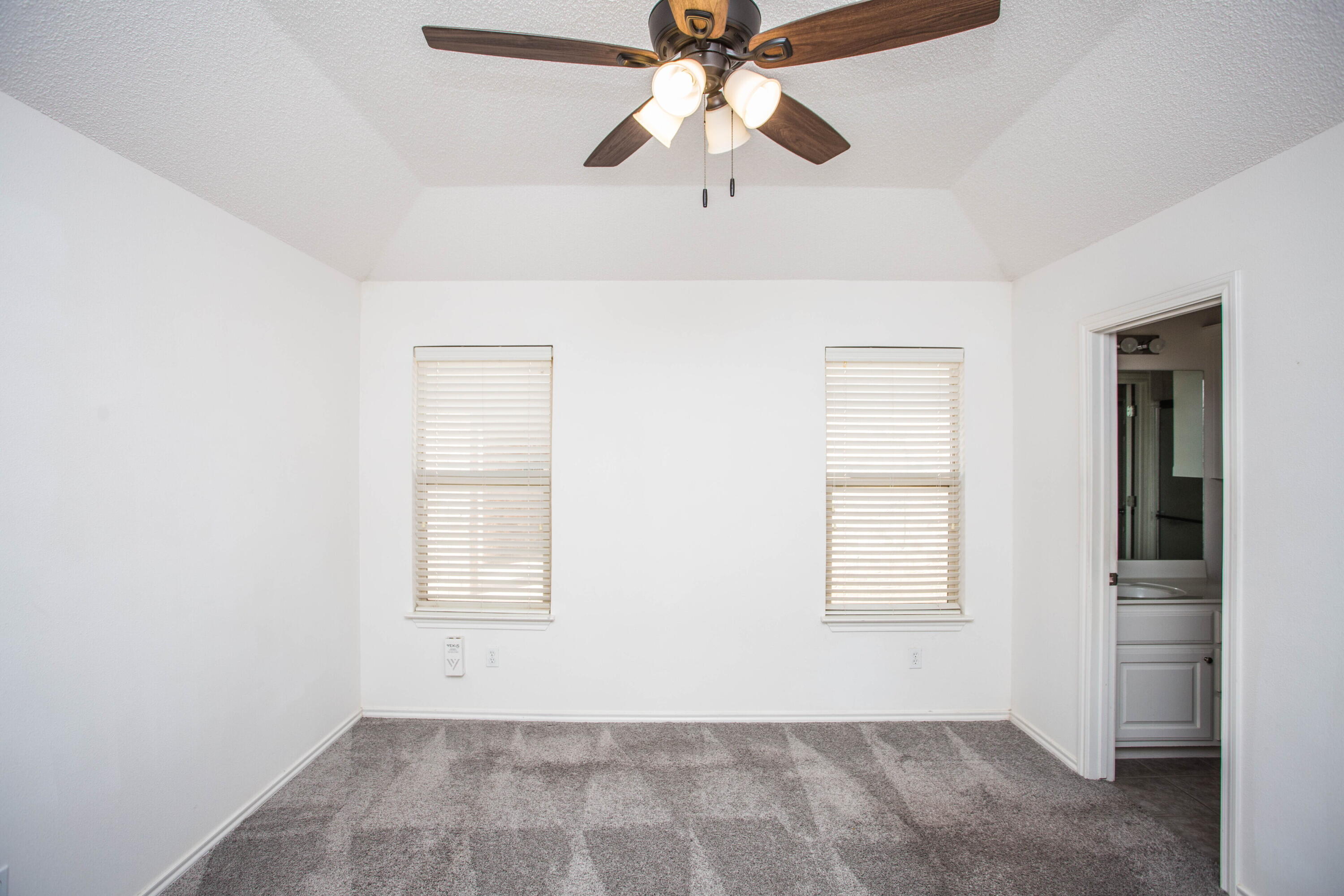 3114 111th Street Lubbock, TX 79423 - Photo 14 of 26 an empty room with windows and fan