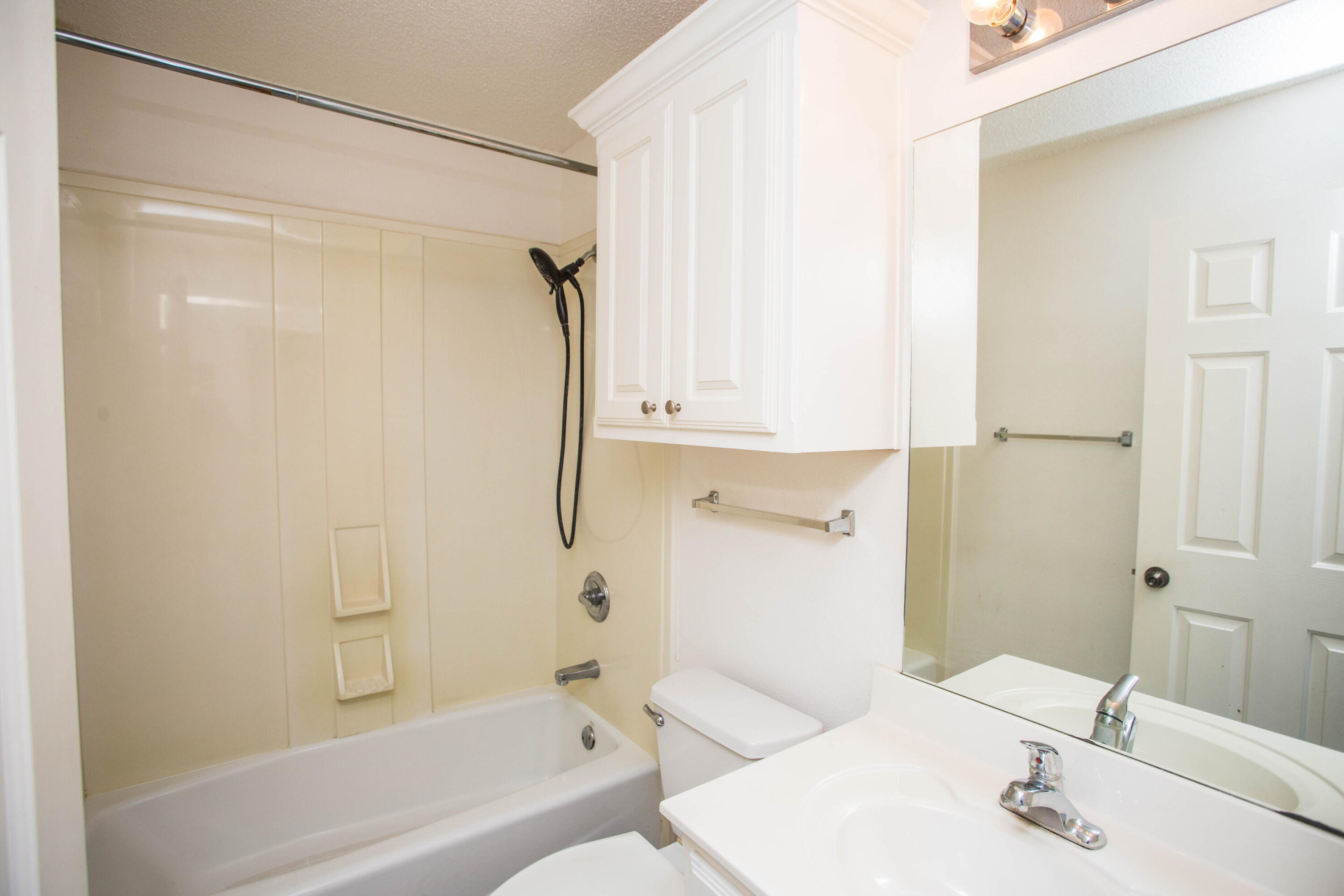 3114 111th Street Lubbock, TX 79423 - Photo 21 of 26 a bathroom with a sink and a mirror