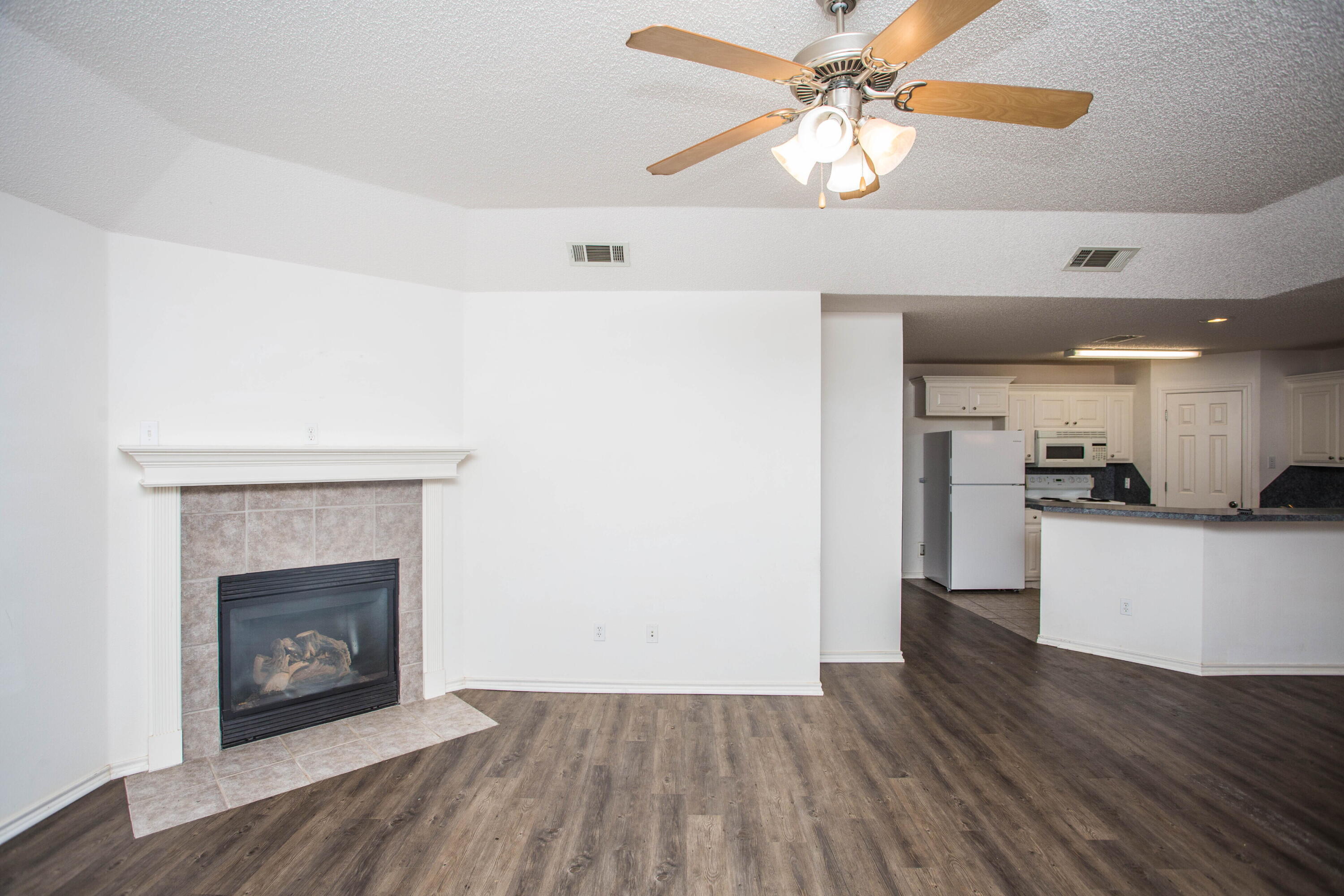 3114 111th Street Lubbock, TX 79423 - Photo 5 of 26 a view of a kitchen with a sink and a fireplace