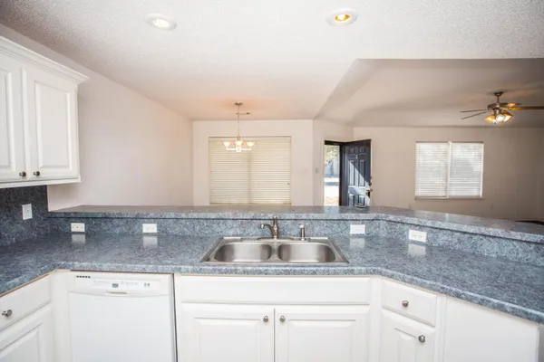 a white refrigerator freezer and a stove sitting inside of a kitchen