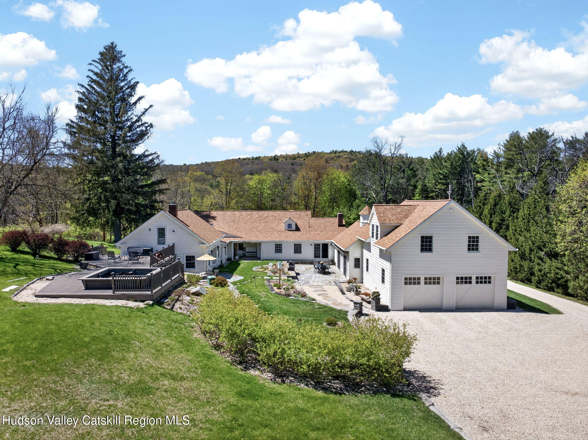 an aerial view of a house with a big yard and large trees