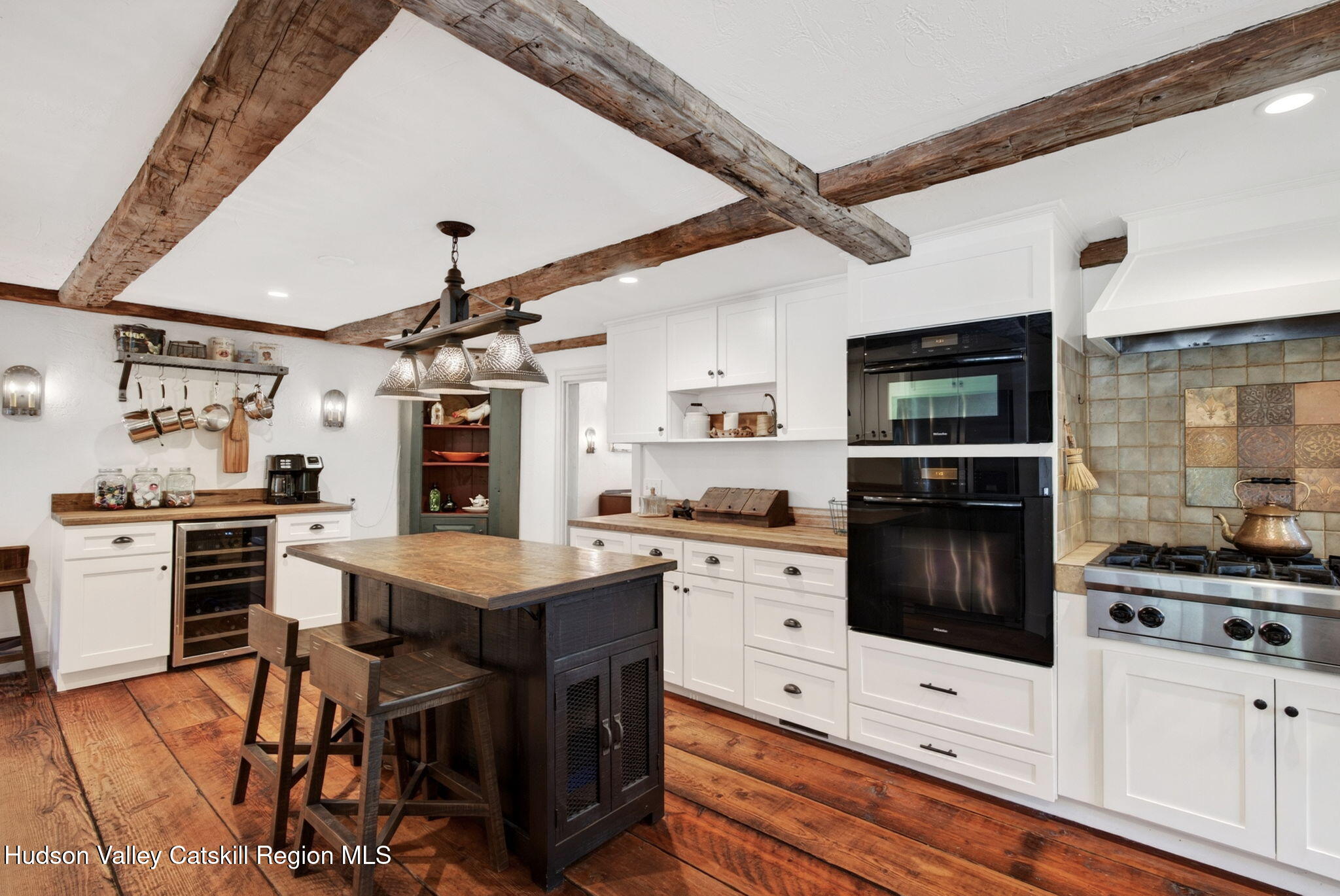 1429 Jackson Corners Road Red Hook, NY 12571 - Photo 5 of 59 a kitchen with stainless steel appliances kitchen island granite countertop a stove top oven a sink dishwasher a dining table and chairs with wooden floor