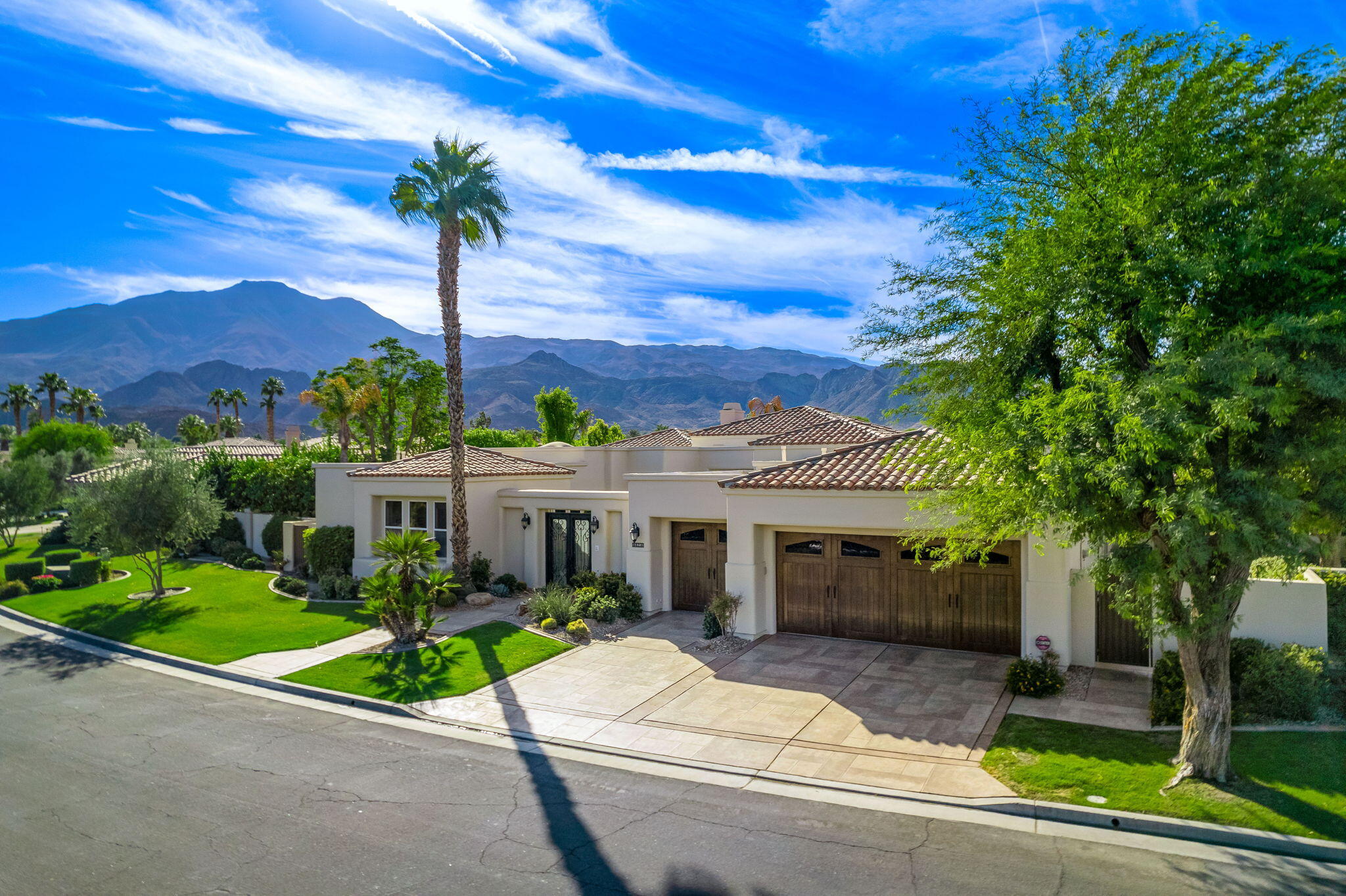80218 Hermitage La Quinta, CA 92253 - Photo 18 of 92 a front view of a house with a garden and trees