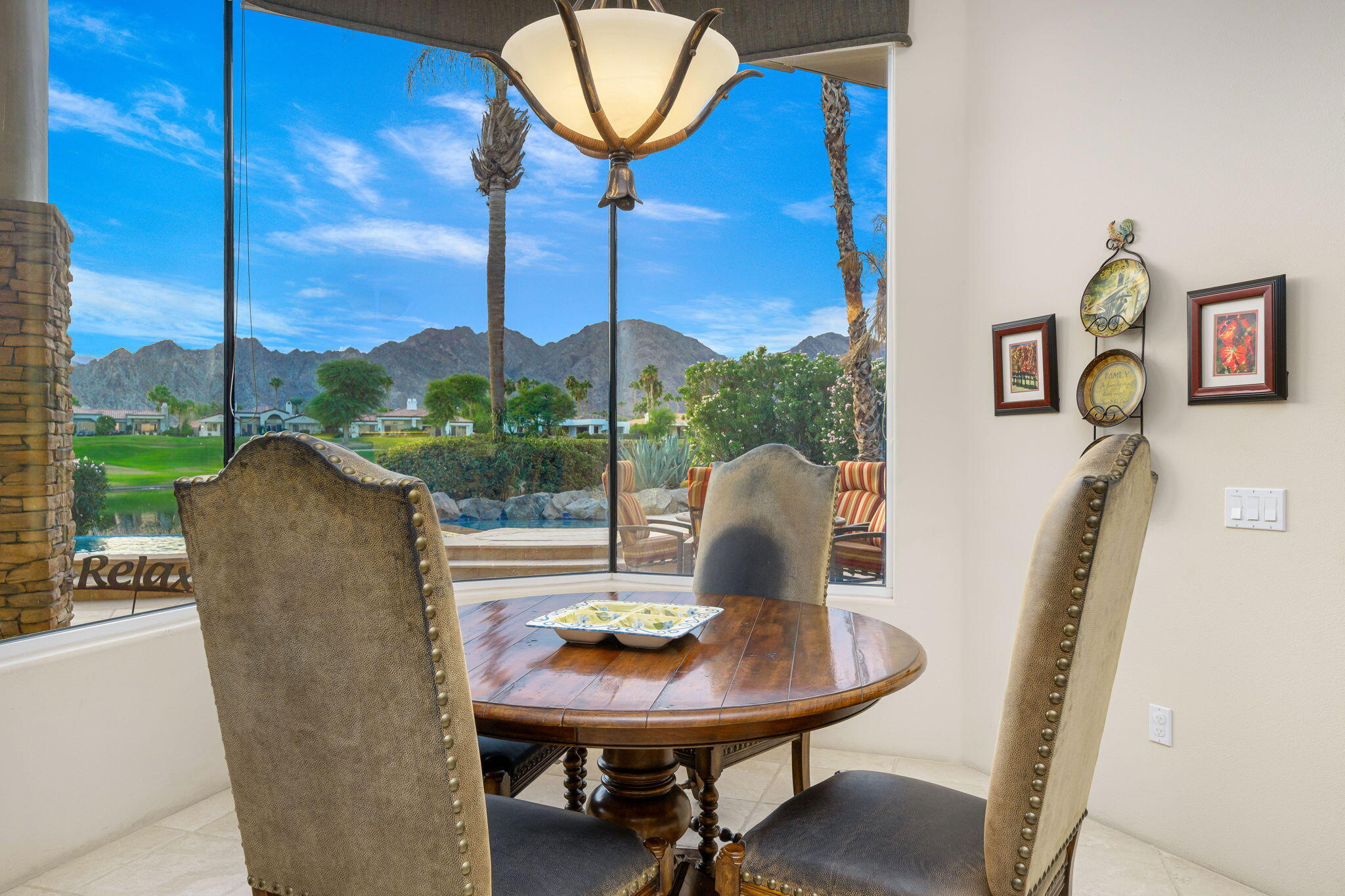 80218 Hermitage La Quinta, CA 92253 - Photo 47 of 92 a view of a dining room with furniture wooden floor and chandelier