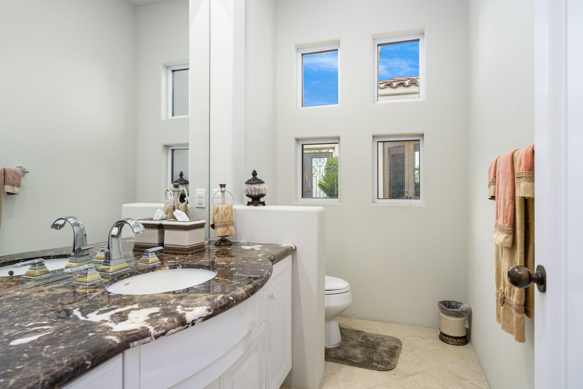 80218 Hermitage La Quinta, CA 92253 - Photo 68 of 92 a bathroom with a granite countertop sink a toilet and a mirror