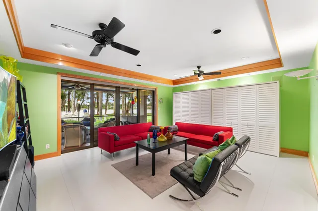 a living room with furniture a fireplace and a large window