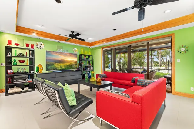 a living room with furniture chess board and a window