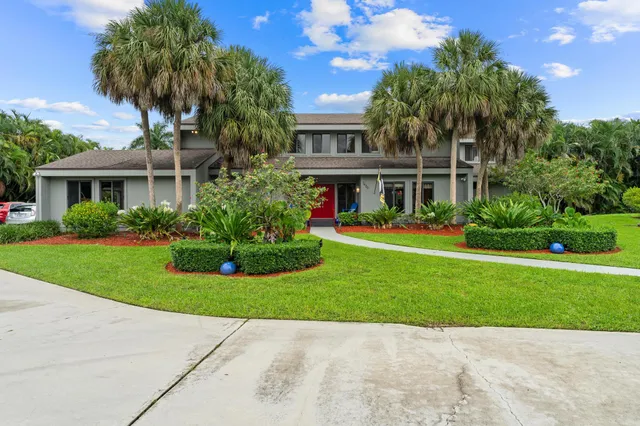 a front view of house with yard and green space