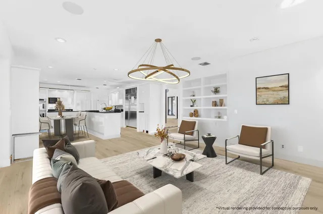 a view of an empty room with chandelier fan and a window