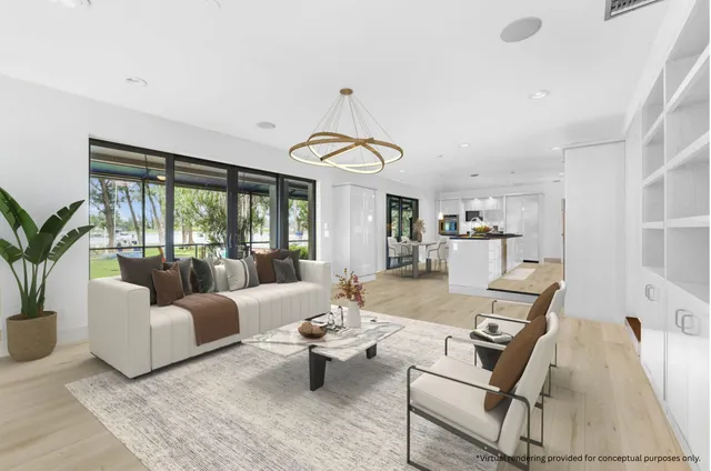 a bedroom with a bed television and a large window