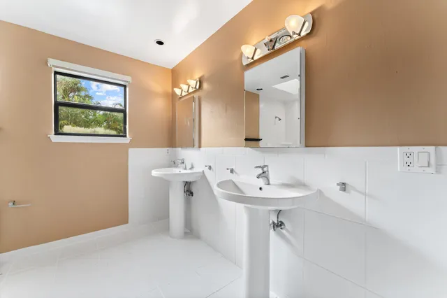 a front view of a house with a yard and outdoor seating