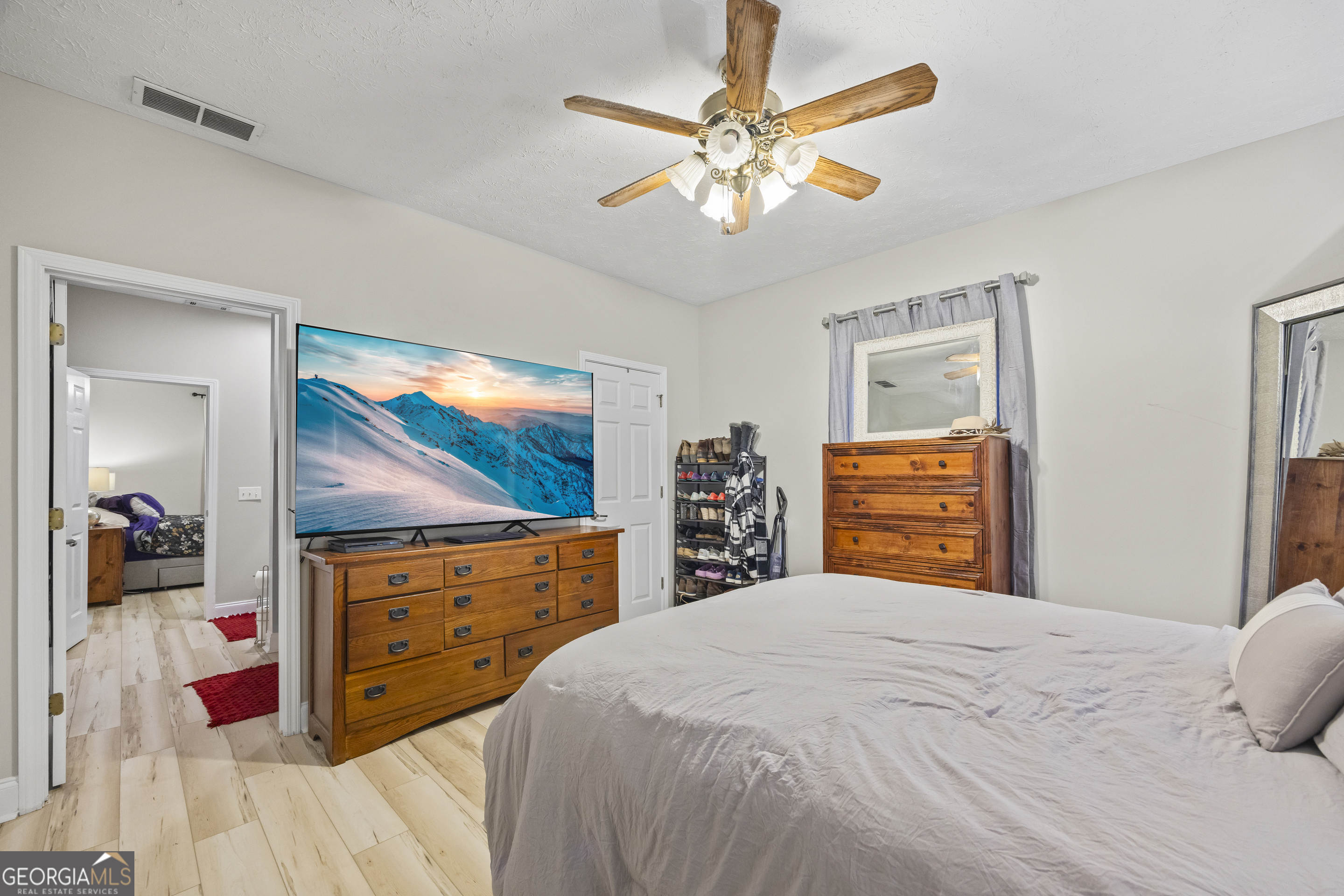 2894 Chase Road Cornelia, GA 30531 - Photo 108 of 142 a bedroom with a bed and a flat screen tv