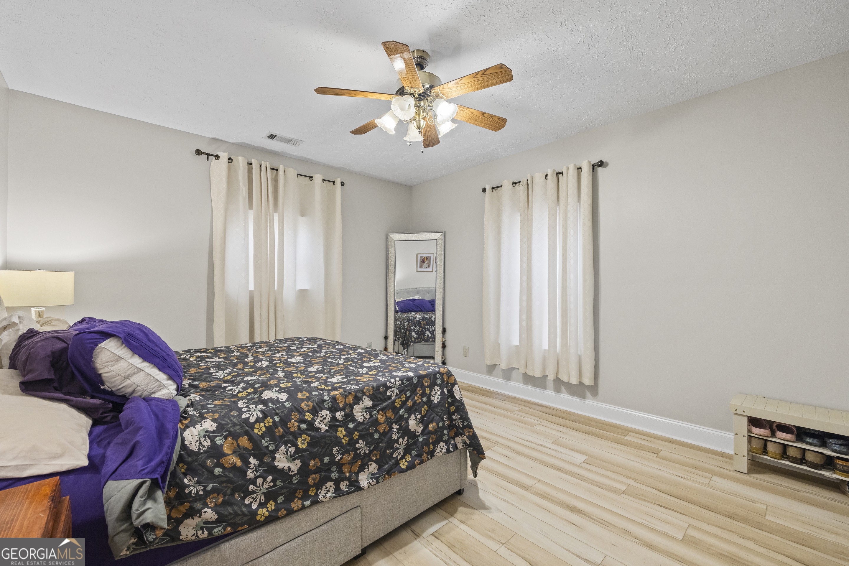 2894 Chase Road Cornelia, GA 30531 - Photo 113 of 142 a bedroom with a large bed and a chandelier