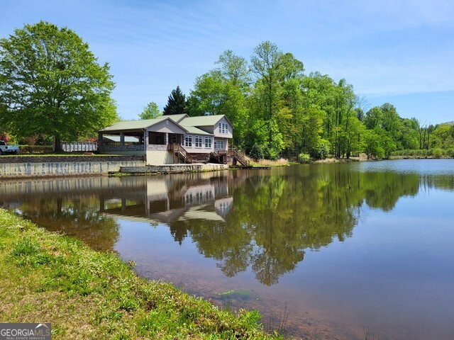 2894 Chase Road Cornelia, GA 30531 - Photo 140 of 142 a view of a house with a yard and a pond