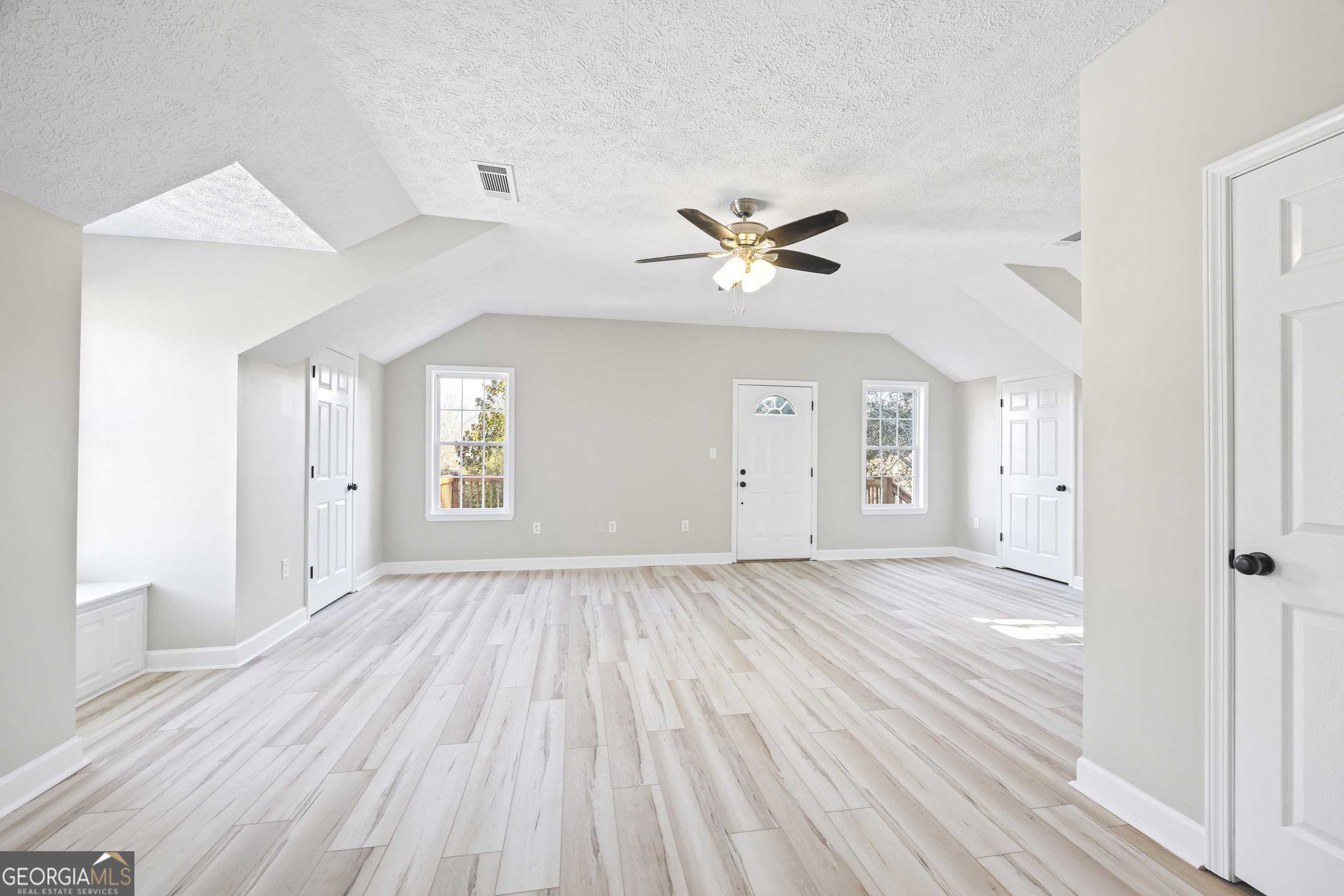 2894 Chase Road Cornelia, GA 30531 - Photo 76 of 142 a view of an empty room with a window and wooden floor