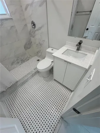 a kitchen with a refrigerator and a stove top oven