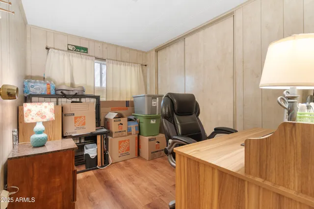 a view of a workspace with furniture and a window