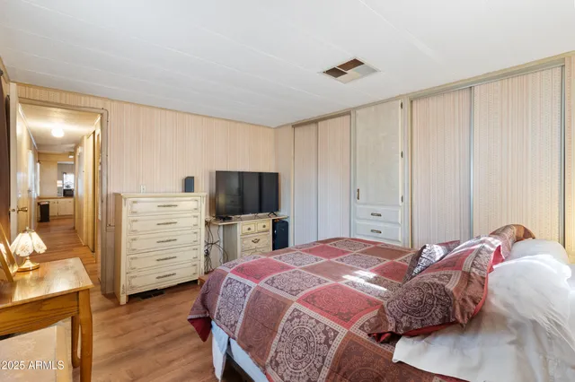 a bedroom with a bed and a television