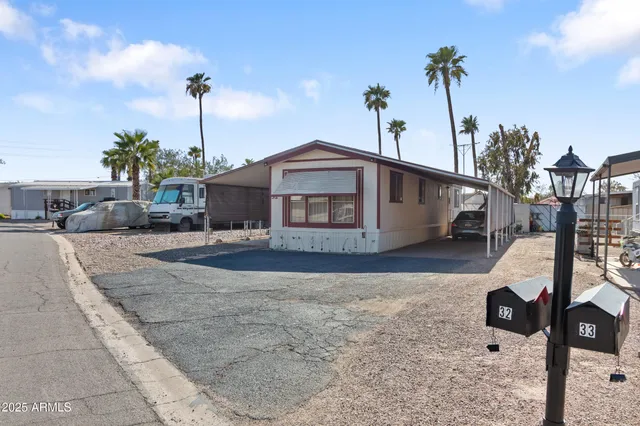 a front view of a house with a garden and yard