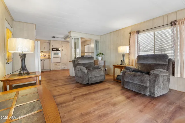 a living room with furniture gym equipment and a large window