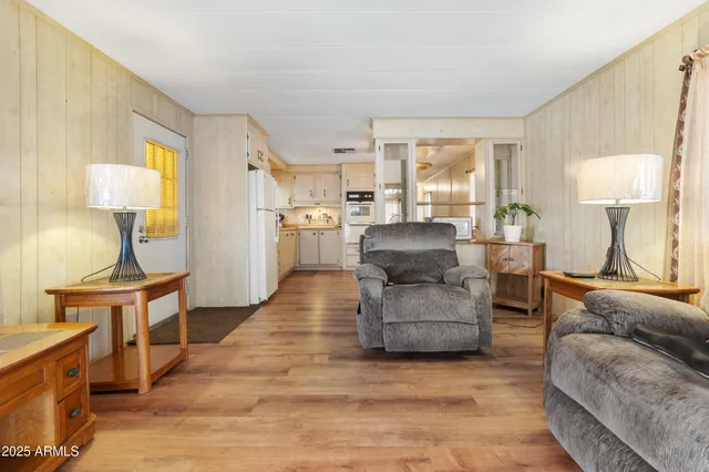 a living room with furniture and a lamp