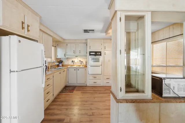 a kitchen with white cabinets and white appliances