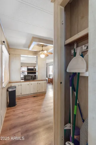 a view of living room kitchen with stainless steel appliances cabinets