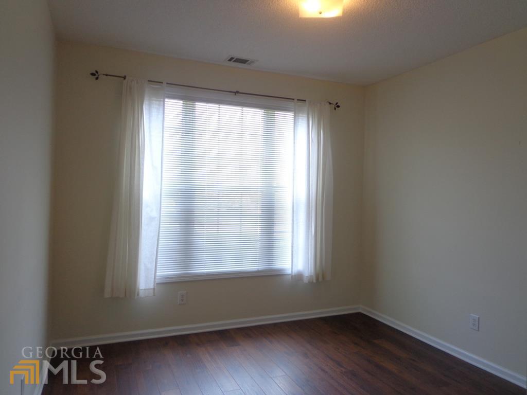 45 Chemin Place Sharpsburg, GA 30277 - Photo 12 of 26 a view of an empty room with wooden floor and a window