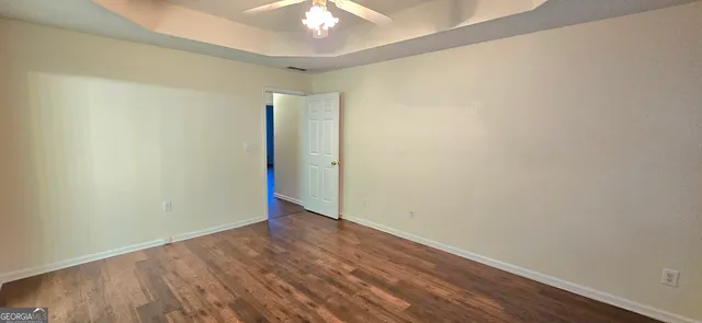 a bathroom with a granite countertop sink toilet a mirror and shower