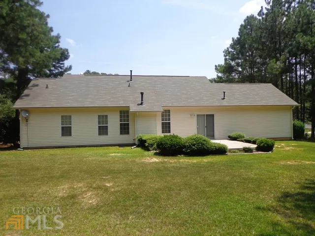 a front view of house with yard and outdoor seating