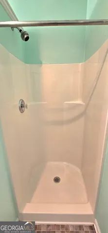 a view of a house with backyard and trees