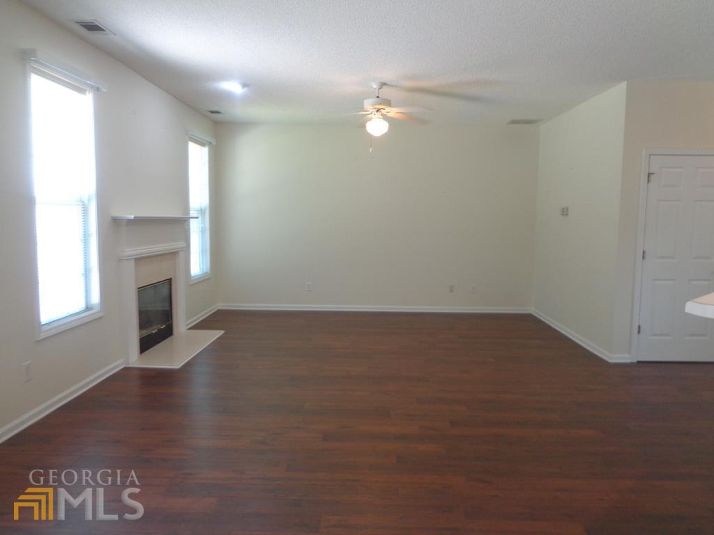 45 Chemin Place Sharpsburg, GA 30277 - Photo 3 of 26 an empty room with wooden floor and windows