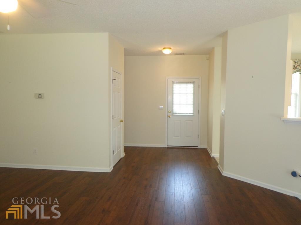 45 Chemin Place Sharpsburg, GA 30277 - Photo 6 of 26 an empty room with wooden floor and windows
