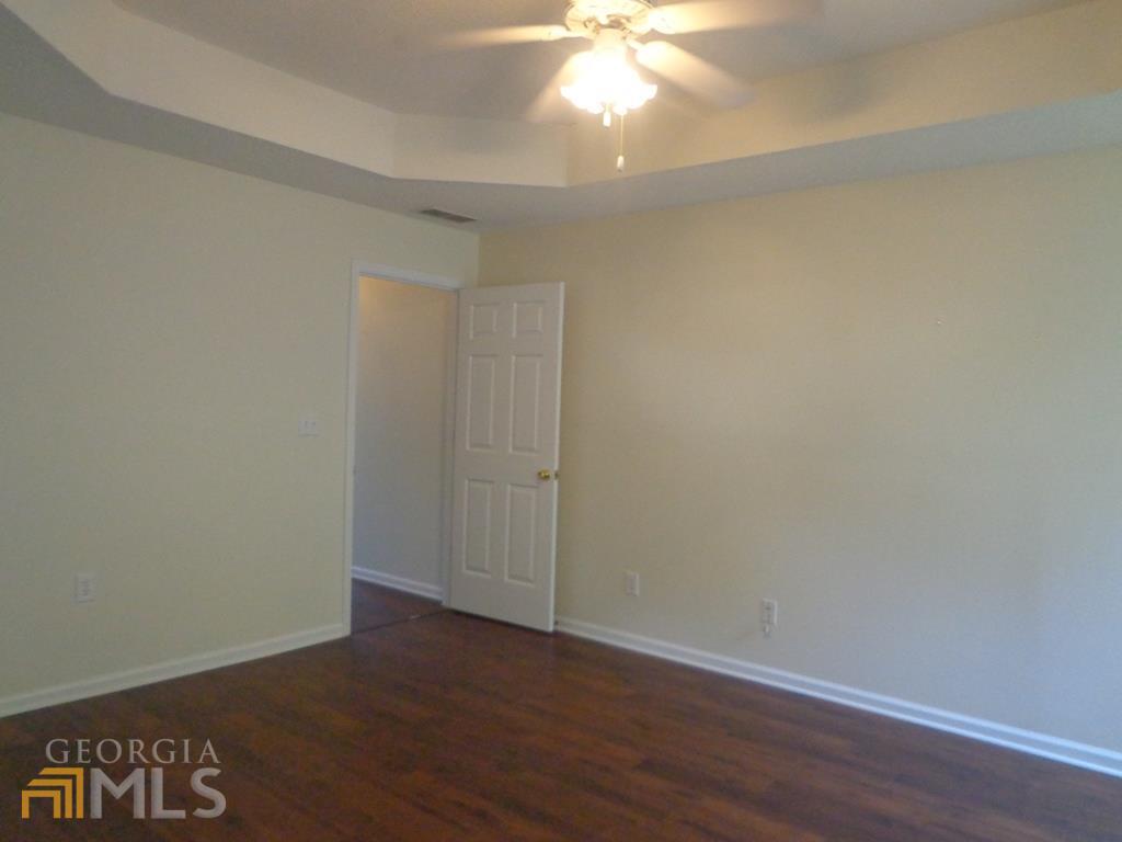 45 Chemin Place Sharpsburg, GA 30277 - Photo 8 of 26 an empty room with wooden floor and fan