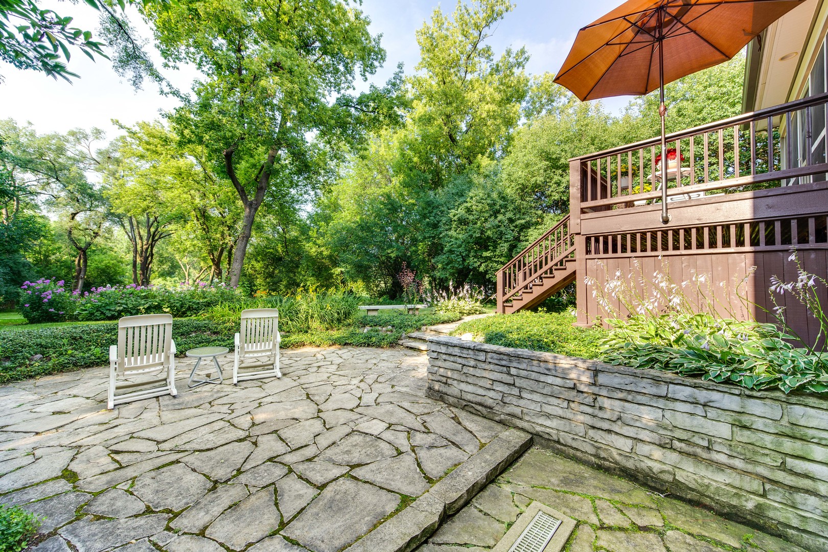 590 West Helen Road Palatine, IL 60067 - Photo 73 of 95 a view of a chair and tables under an umbrella in the front of the house