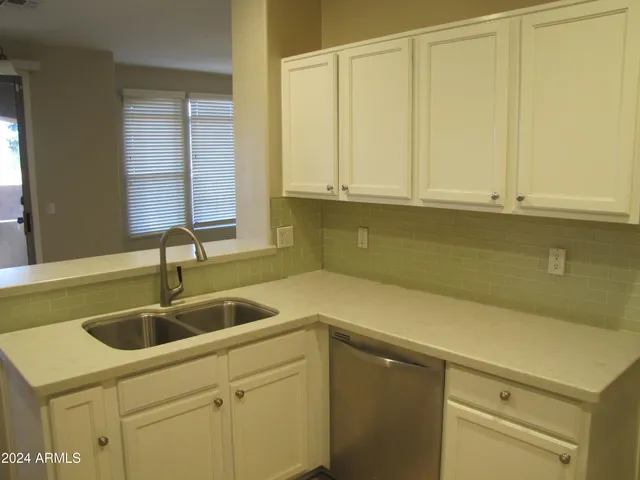 a kitchen with a sink and cabinets