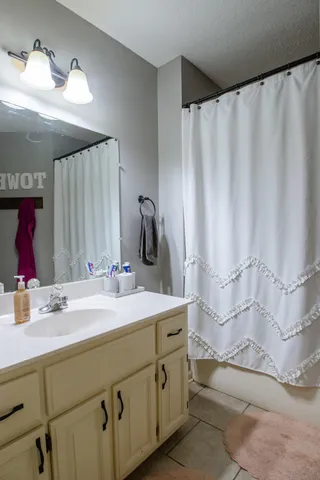 a bathroom with a double vanity sink and a mirror