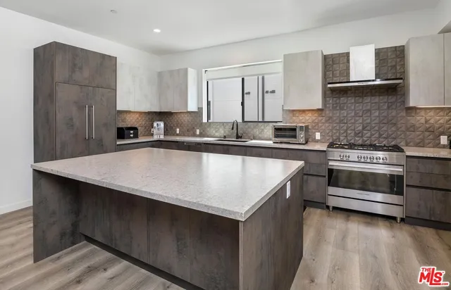 a kitchen with a stove a sink and a refrigerator