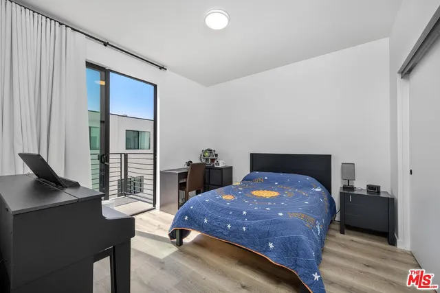 a bedroom with a bed and a desk