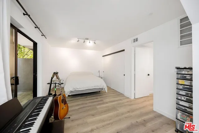 a bedroom with furniture and wooden floor