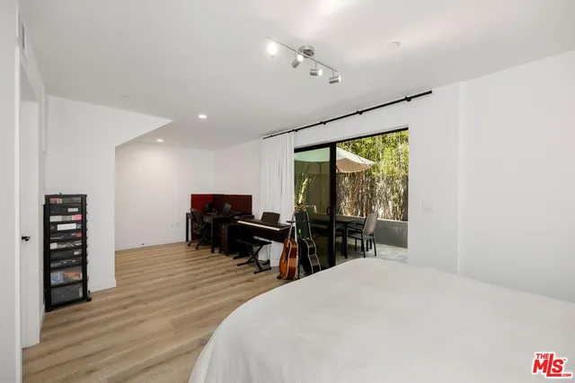 a bedroom with furniture and a large window
