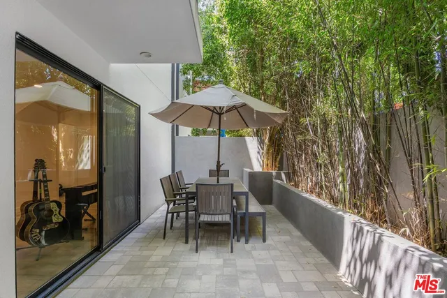 a view of a chairs and table in the balcony