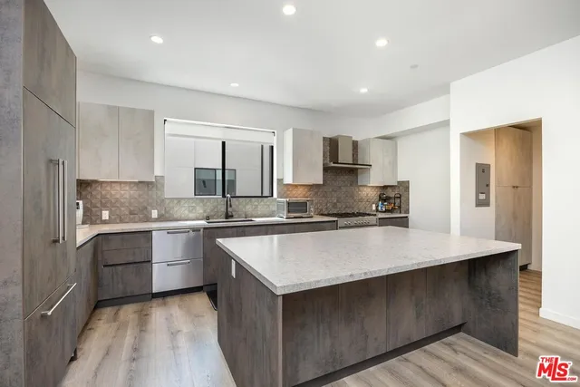 a kitchen with stainless steel appliances granite countertop a sink counter space and cabinets