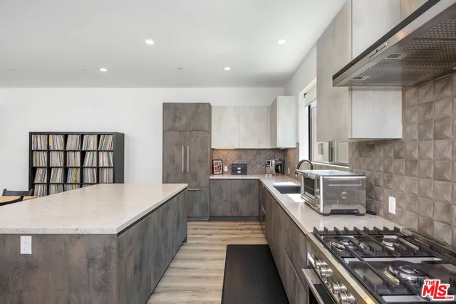 a kitchen with stainless steel appliances granite countertop a stove a sink dishwasher and a refrigerator